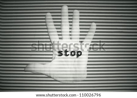 Open hand with the writing - stop - on the palm in black and white