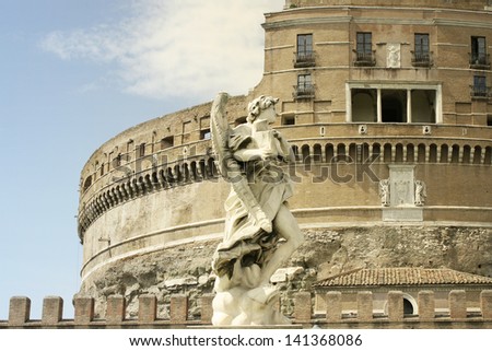 Wonderful detail of an angel statue with the wonderful Castle of the Holy Angel in Rome