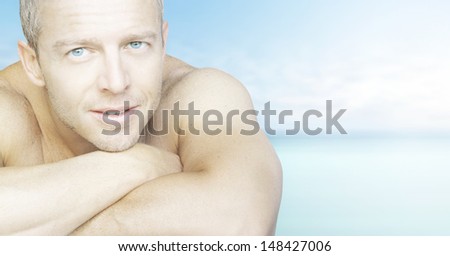 Handsome young male model portrait with sea on the background