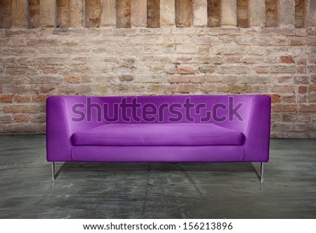 Minimalist modern purple sofa in a unusual environment antique brick wall