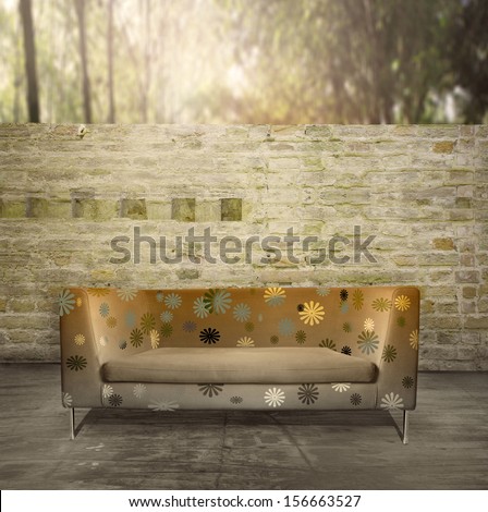 Modern golden sofa in a unusual environment with an antique brick wall and plants in the background