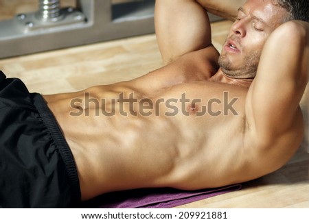 Handsome male model lie down doing abdominal
