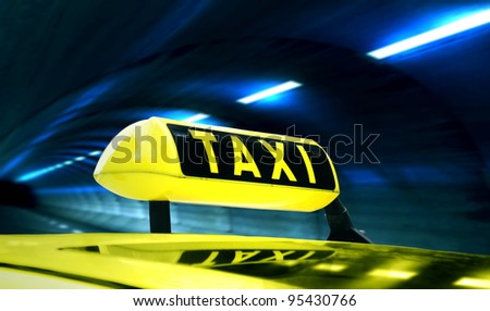 Yellow Taxi in a tunnel at night