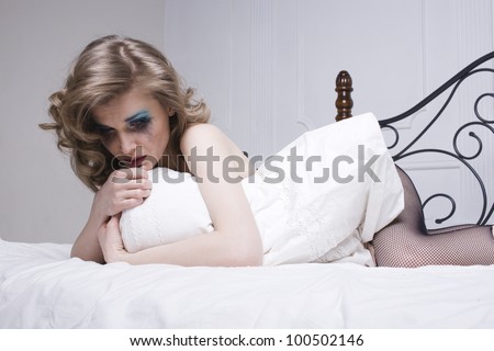 crying woman laying in bed