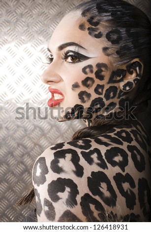 portrait of beautiful young european model in cat make-up and bodyart