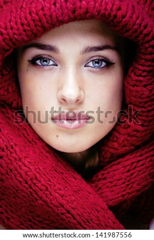 Young Pretty Woman In Sweater And Scarf All Over Her Face