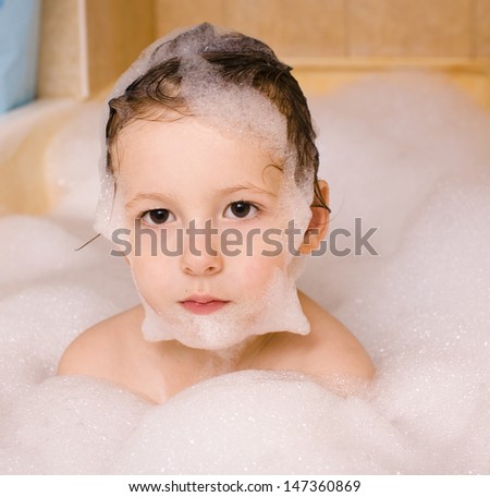 cute little boy in bathroom with foam