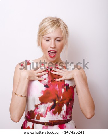 blond emotional woman with red lips and nails