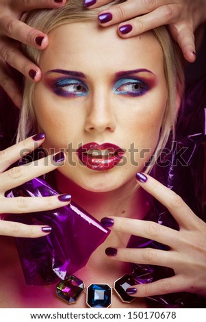 beauty woman with creative make up, many fingers on face close up