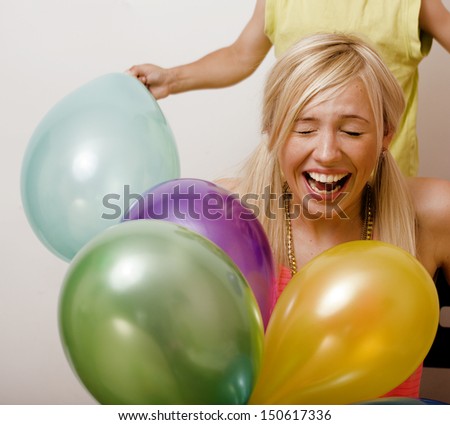 pretty family with color balloons on white background, blond woman with little boy on birthday party