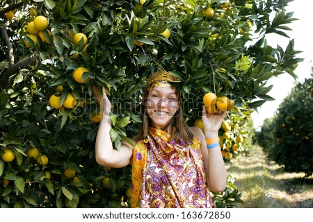 pretty islam woman in orange grove smiling
