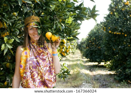 pretty Islam woman in orange grove smiling