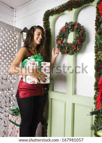 happy young girl at home decorated on Christmas, bringing gifts to friends