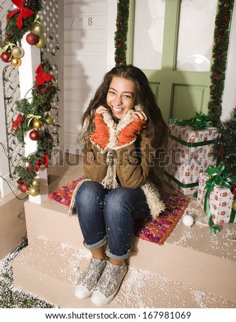 happy young girl at home decorated on Christmas, bringing gifts to friends