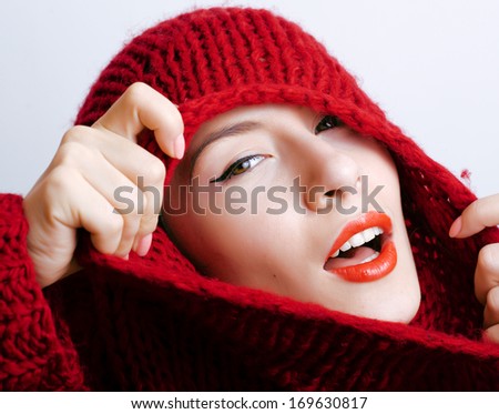 young pretty woman in sweater and scarf all over her face