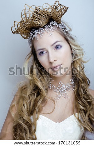 beauty young snow queen in fairy flashes with crown on her head
