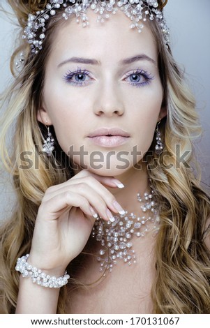 beauty young snow queen in fairy flashes with crown on her head