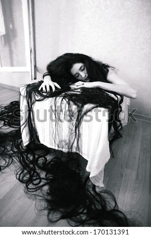 beauty girl cuting her hair in empty fearing room with cutted hair