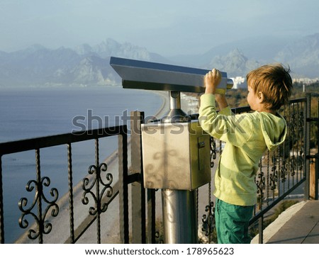 little cute boy looking through telescope at sea viewpoint in Ataturk park