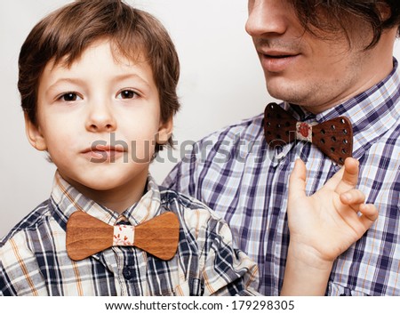 father with son in bowties on white background, casual look
