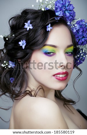 Beauty young woman with flowers and make up close up, real spring beauty