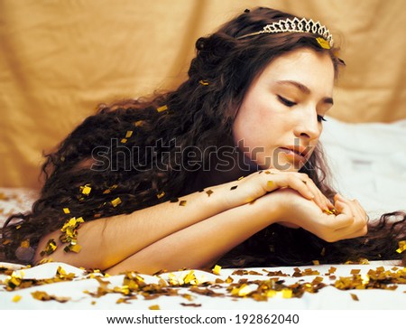 beauty young girl in gold confetti and tiara, little princess celebration