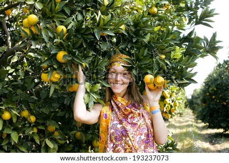 pretty woman in orange grove smiling