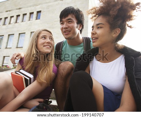 cute group of teenages at the building of university with books huggings