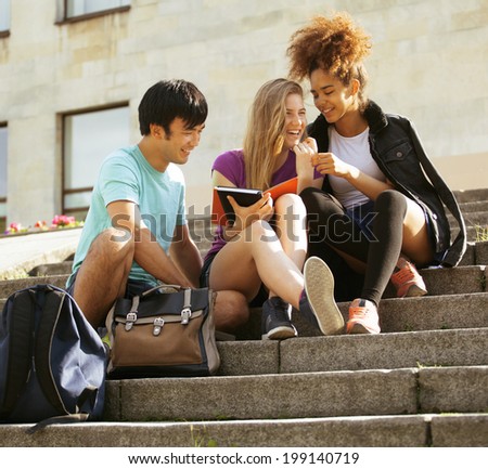 cute group of teenages at the building of university with books huggings