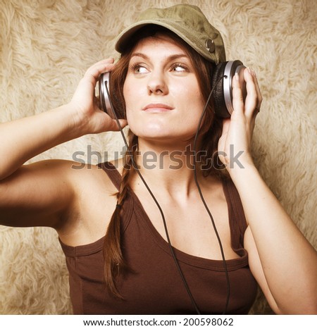 beauty young girl listening music in headphones close up