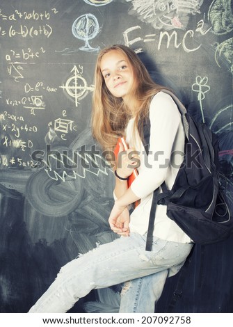 back to school after summer vacations, cute teen girl in classroom