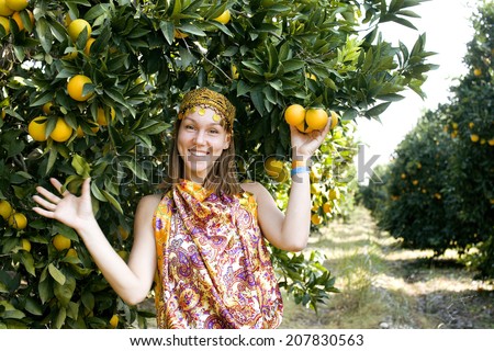 pretty islam woman in orange grove smiling