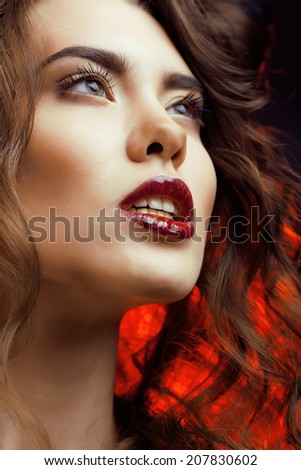 Beauty Woman with Perfect Makeup Beautiful Professional Holiday Make-up. Red Lips and Nails Beauty Girls Face isolated on Black background Glamorous Woman