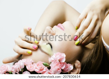 Beauty young woman with flowers and makeup close up, spa treatment