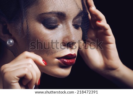 beauty brunette woman under black veil with red manicure close up, grieving widow, halloween makeup