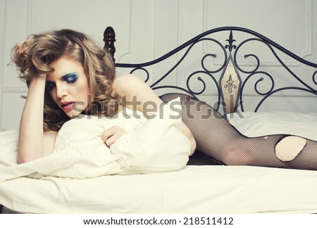 crying woman laying in bed depressed