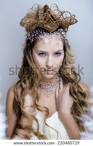 beauty young snow queen in fairy flashes with hair crown on her head
