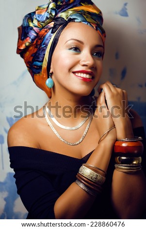 beauty bright african woman with creative make up, shawl on head like cubian  closeup
