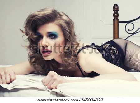 crying woman laying in bed depressed, real blond