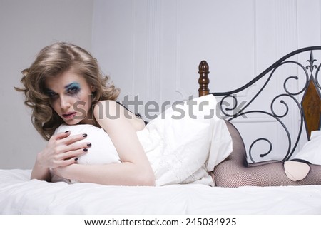 crying woman laying in bed depressed, real blond