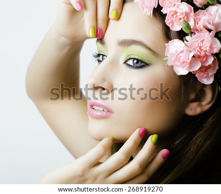 Beauty young real woman with flowers and make up closeup, nails with manicure
