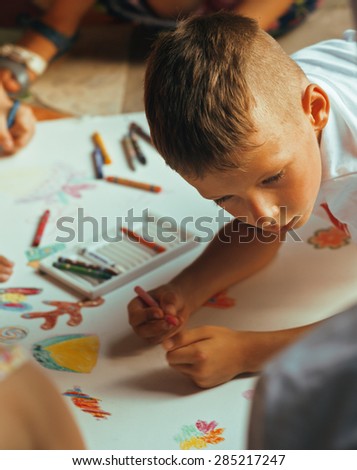 little cute boy with company painting on birthday party together