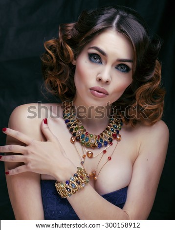 beauty rich woman with luxury jewellery looks like mature close up on black