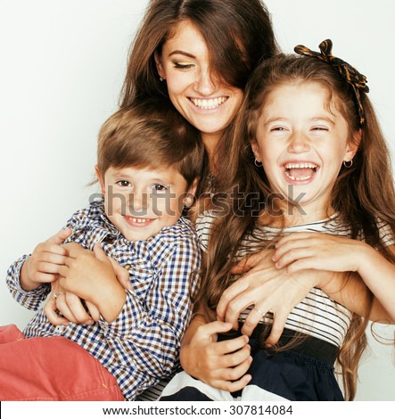 young mother with two children on white, happy smiling family inside close up