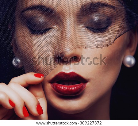 beauty brunette woman under black veil with red manicure close up, grieving widow, halloween makeup luxury