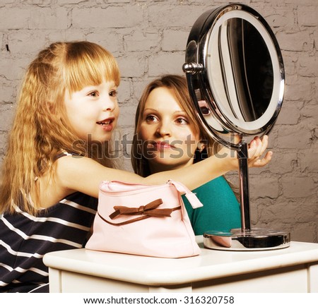 young family mother and daughter make up at mirror, learning use cosmetic close up