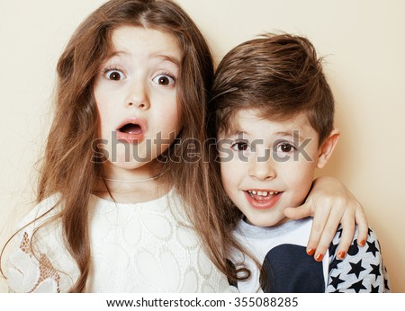 little cute boy and girl hugging playing on white background, happy family smiling brother and sister