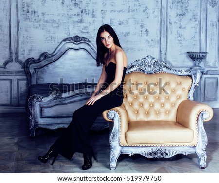 beauty young brunette woman in luxury home interior, fairy bedroom grey stylish