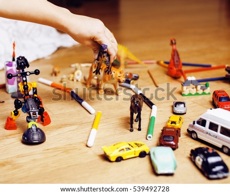 children playing toys on floor at home, little hand in mess, free education
