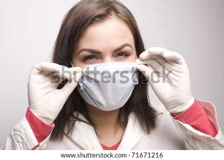 portrait of young beauty doctor in medical mask